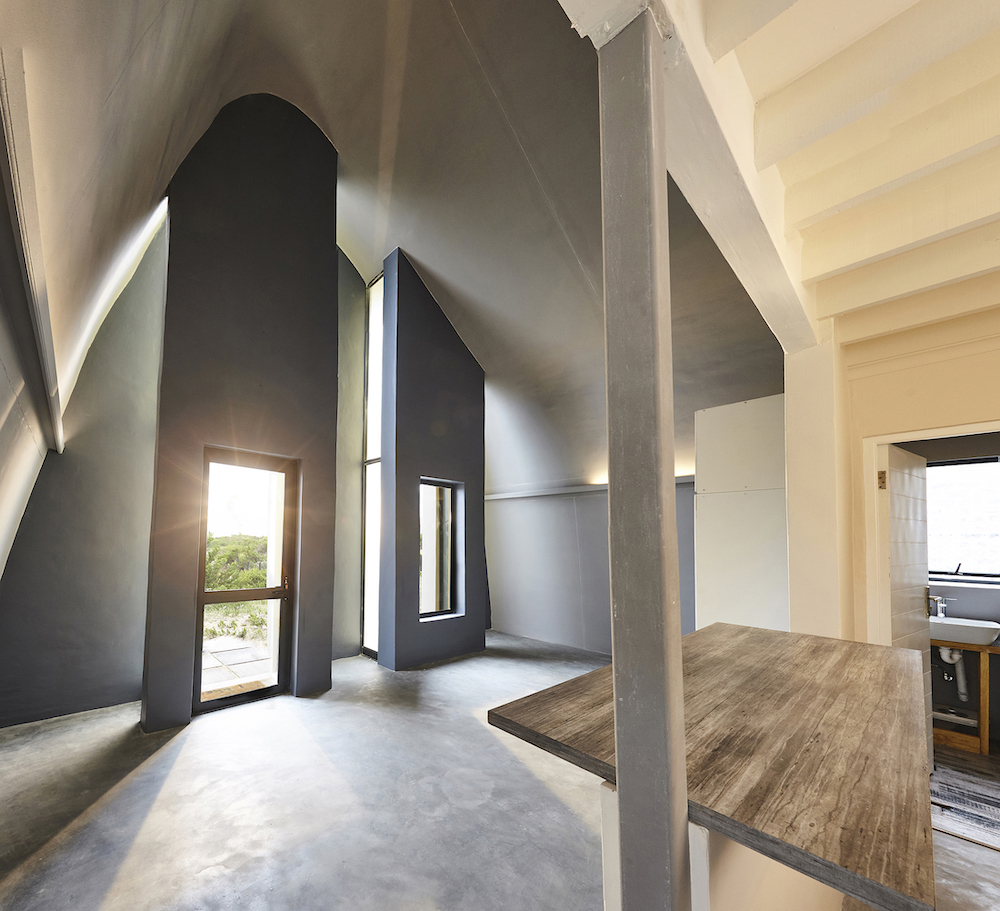 An interior view of House Mahika showcasing its high, curved ceiling.